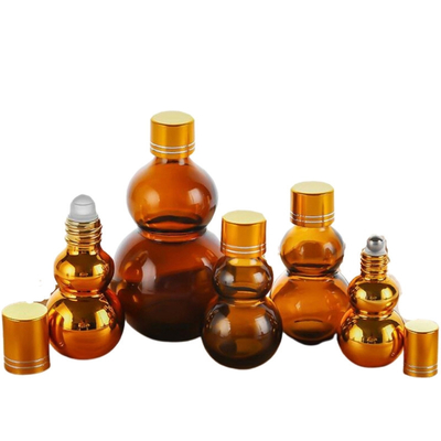 Botellas de aceite de perfume de vidrio ámbar personalizables de 10 ml/50 ml/100 ml con acabado dorado espejo, tapas doradas dobles y base engrosada